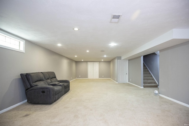 living area featuring stairway, baseboards, recessed lighting, and light colored carpet