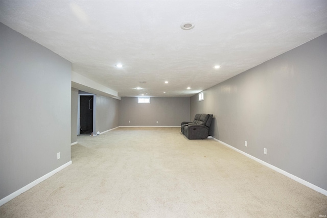 basement with light carpet, baseboards, and recessed lighting