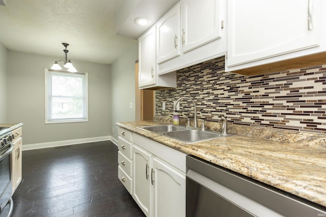 kitchen featuring appliances with stainless steel finishes, a sink, decorative backsplash, baseboards, and white cabinets