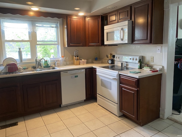 606 E Walnut St, Portland, IN 47371 - kitchen featuring white appliances, light countertops, light tile patterned floors, recessed lighting, and dark brown cabinets
