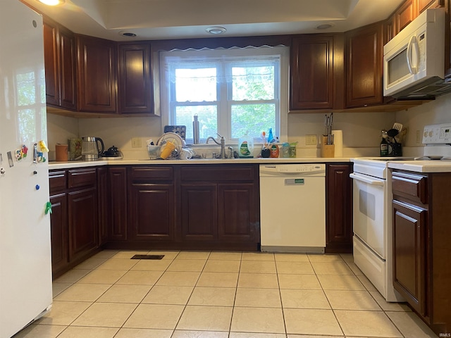 606 E Walnut St, Portland, IN 47371 - kitchen with white appliances, light countertops, light tile patterned floors, and dark brown cabinets