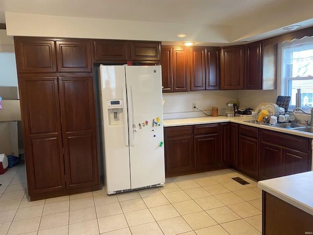606 E Walnut St, Portland, IN 47371 - kitchen with white fridge with ice dispenser, light countertops, and light tile patterned floors