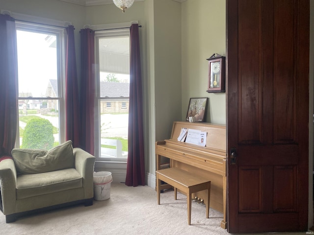 living area with healthy amount of natural light and light carpet
