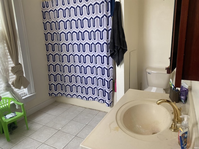 bathroom featuring a sink, tile patterned floors, a shower with shower curtain, and toilet