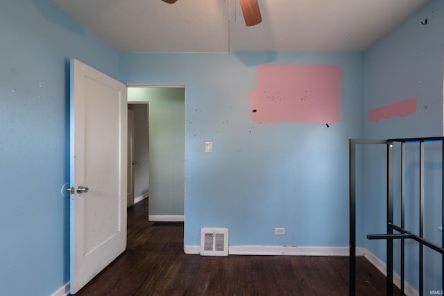 unfurnished bedroom featuring wood finished floors, baseboards, and ceiling fan