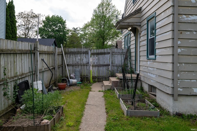 view of yard with a vegetable garden and fence