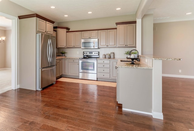 3121 Ralston Dr, Evansville, IN 47715 - kitchen with appliances with stainless steel finishes, a sink, a peninsula, ornamental molding, and baseboards