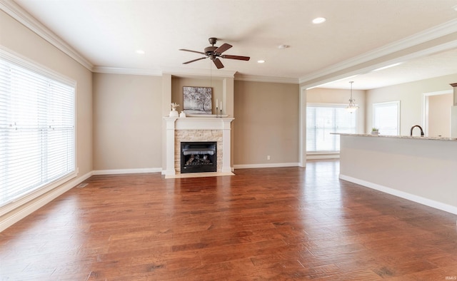 3121 Ralston Dr, Evansville, IN 47715 - unfurnished living room featuring a ceiling fan, ornamental molding, a stone fireplace, baseboards, and recessed lighting