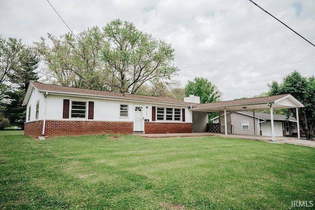 ranch-style home with brick siding, a front lawn, and a chimney