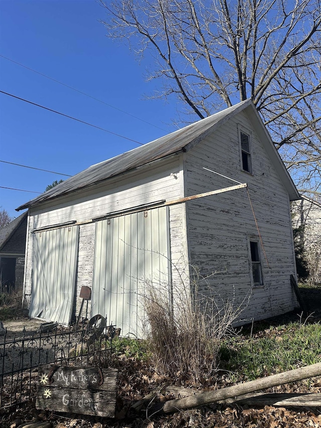 306 Wabash St, Berne, IN 46711 - view of side of home with an outdoor structure and fence