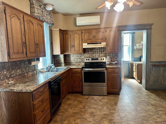 306 Wabash St, Berne, IN 46711 - kitchen with stainless steel electric range, dishwasher, under cabinet range hood, a wall unit AC, and a sink