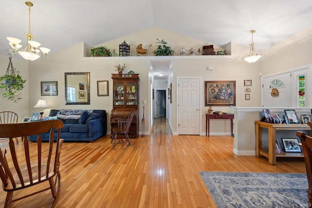 5132 Dunbar Dr, Lafayette, IN 47905 - living area with lofted ceiling, light wood-style flooring, and a chandelier