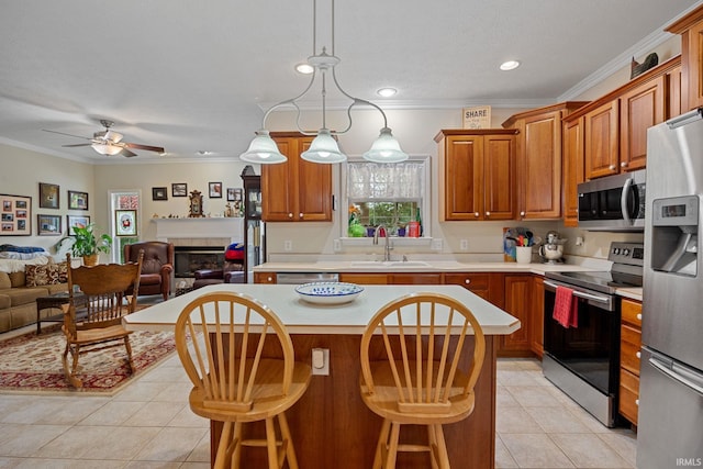 5132 Dunbar Dr, Lafayette, IN 47905 - kitchen featuring stainless steel appliances, open floor plan, light tile patterned floors, a sink, and light countertops