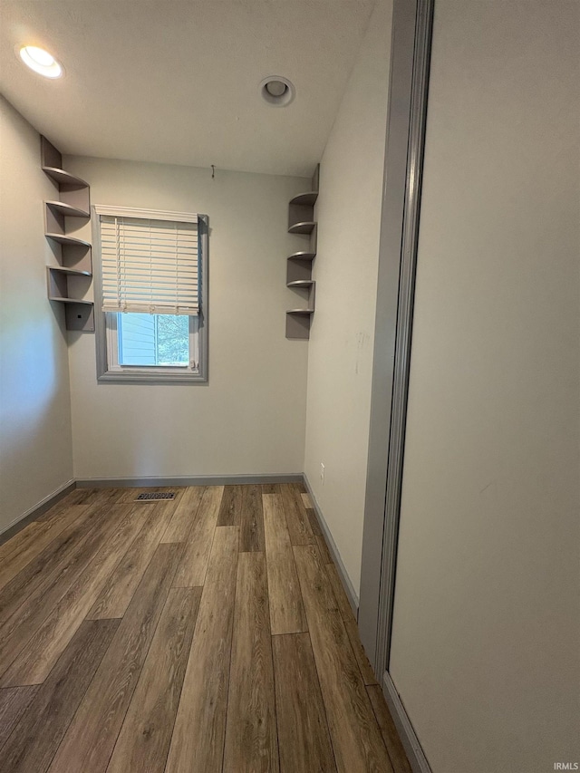 spare room with dark wood finished floors, baseboards, and recessed lighting
