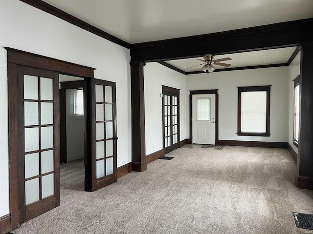 spare room with french doors, carpet, ornamental molding, baseboards, and ceiling fan