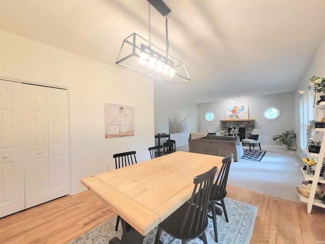 dining room featuring light wood-type flooring and baseboards