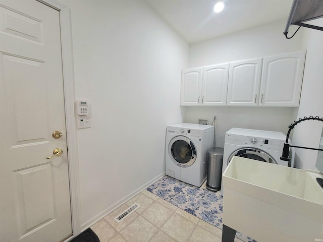 laundry area with independent washer and dryer, baseboards, cabinet space, light flooring, and recessed lighting
