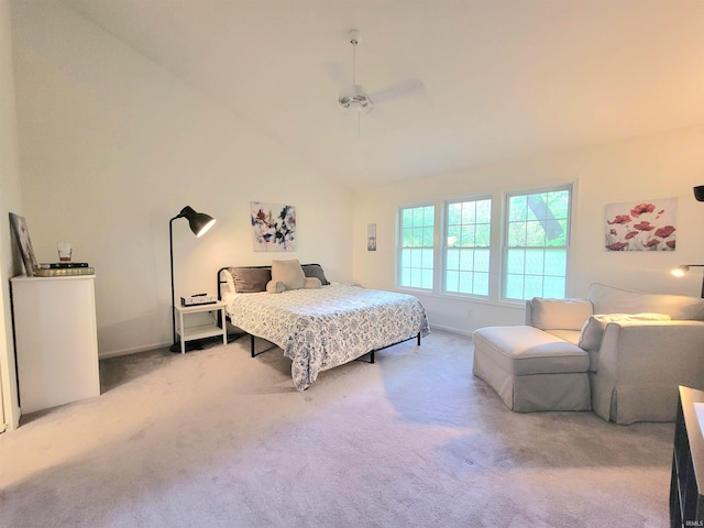 carpeted bedroom featuring baseboards, ceiling fan, and high vaulted ceiling