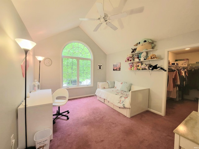 carpeted bedroom featuring lofted ceiling, a walk in closet, baseboards, ceiling fan, and a closet