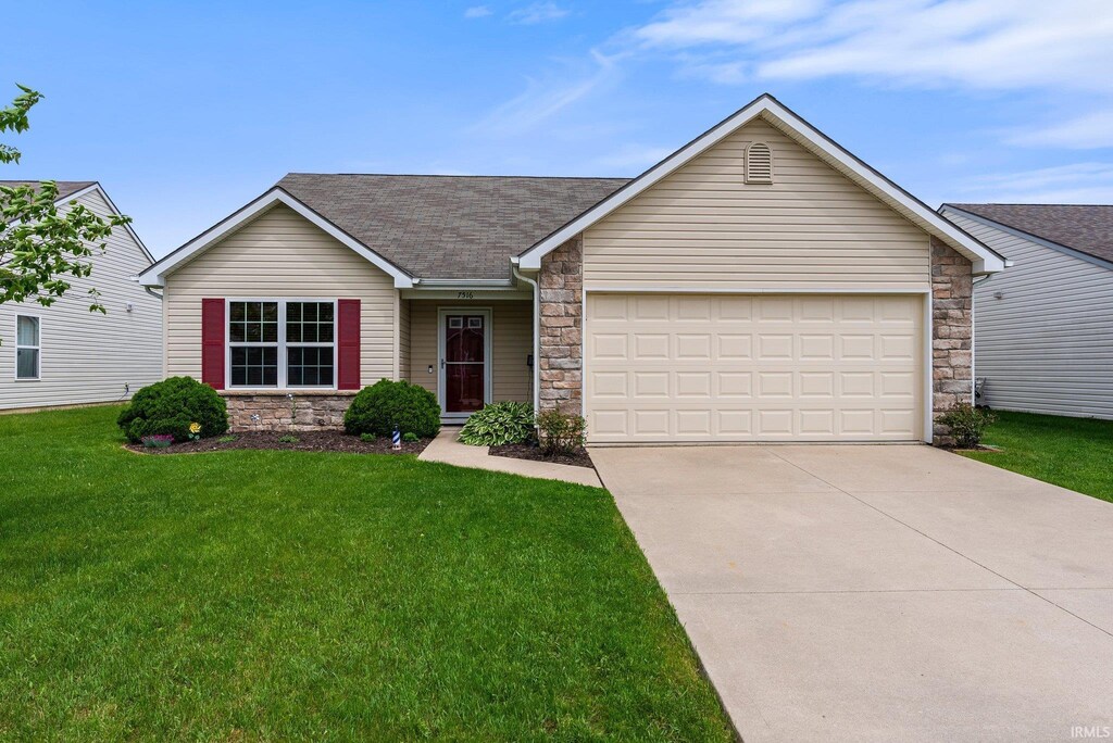 7516 Haida Way, Fort Wayne, IN 46818 - ranch-style home with stone siding, driveway, a garage, and a front lawn