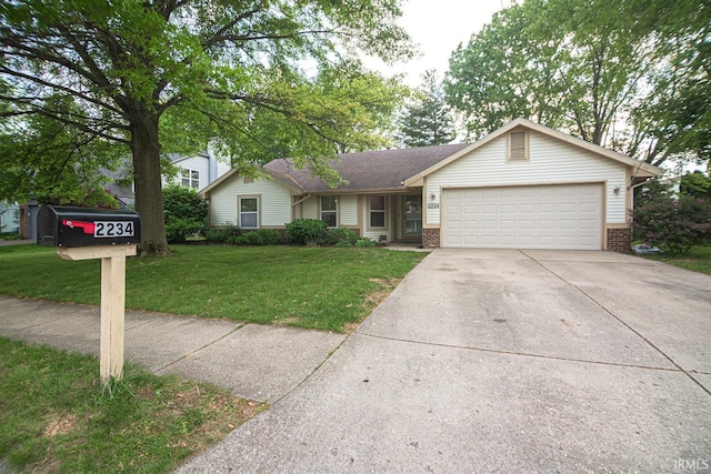single story home featuring brick siding, an attached garage, driveway, and a front yard