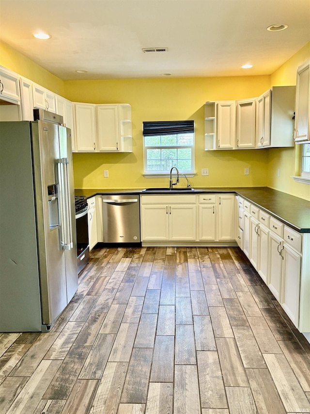 3051 Bluster Ct, West Lafayette, IN 47906 - kitchen with stainless steel appliances, a sink, open shelves, dark countertops, and plenty of natural light