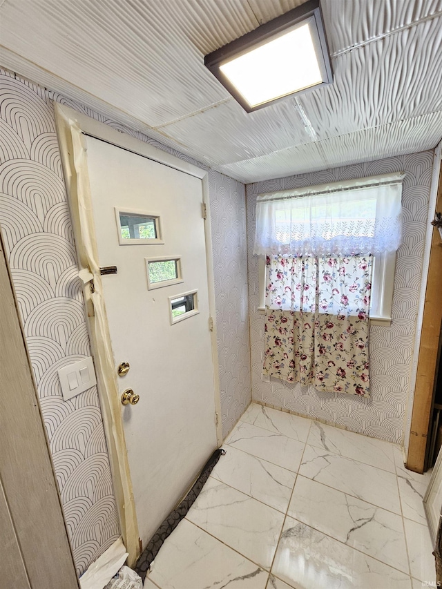 entryway with marble finish flooring