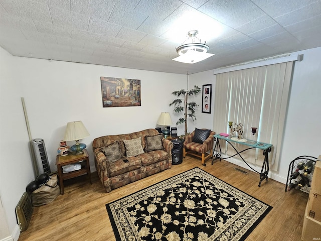 living area with wood finished floors and baseboards