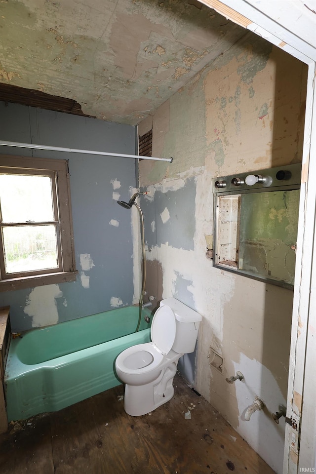 bathroom featuring toilet, a bathtub, a shower, and wood finished floors