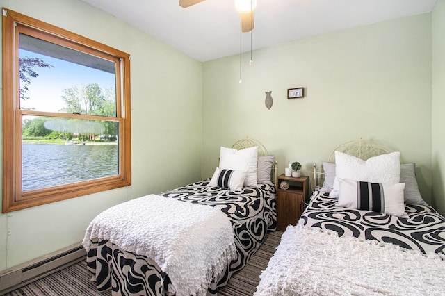 bedroom with a baseboard heating unit and a ceiling fan