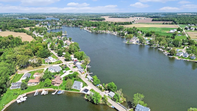 aerial view of property's location with a large body of water and nearby suburban area