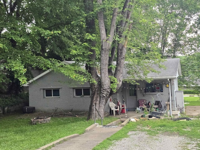 380 Sorenson Ave, Evansville, IN 47712 - rear view of property featuring brick siding, a yard, and a chimney