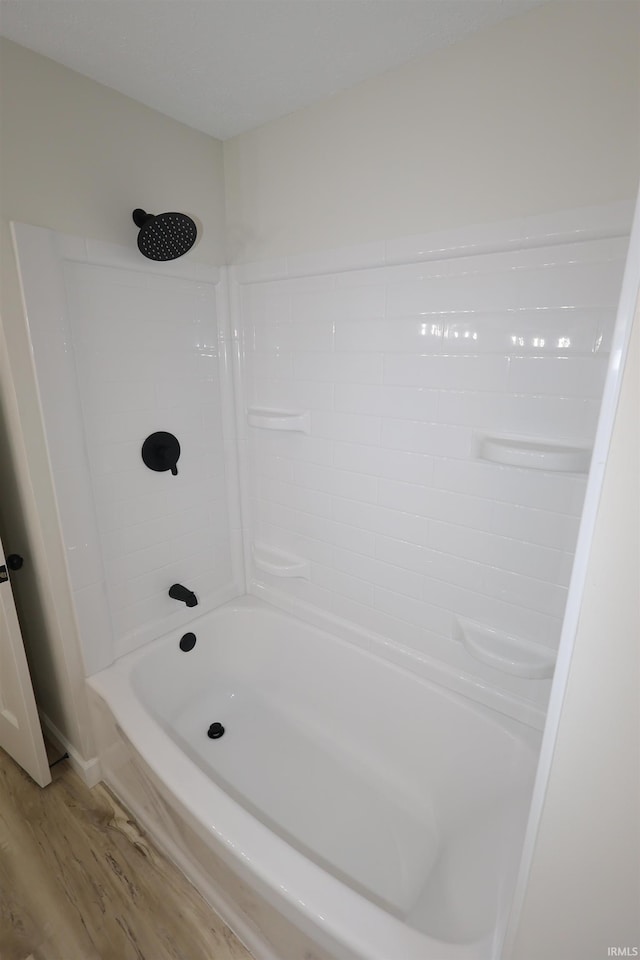 full bathroom with wood finished floors and shower / bath combination