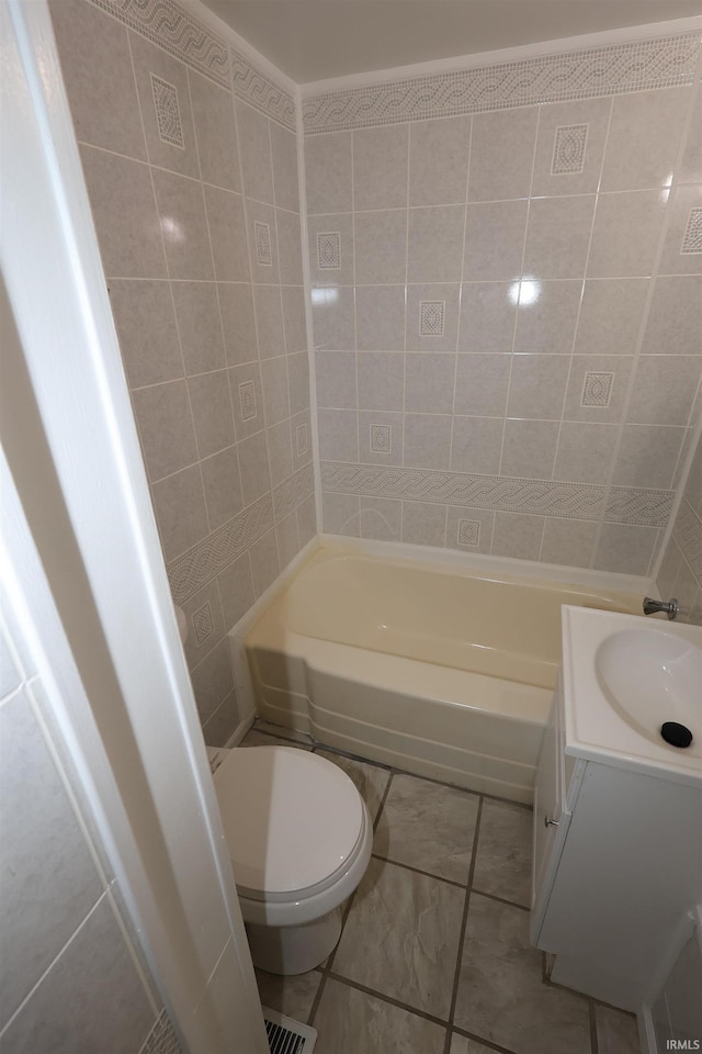 bathroom featuring vanity, toilet, and tile patterned flooring