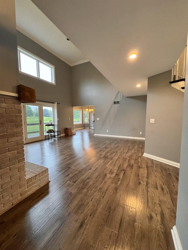 1953 S Troon Rd, Winona Lake, IN 46590 - unfurnished living room featuring dark wood finished floors, baseboards, and a towering ceiling