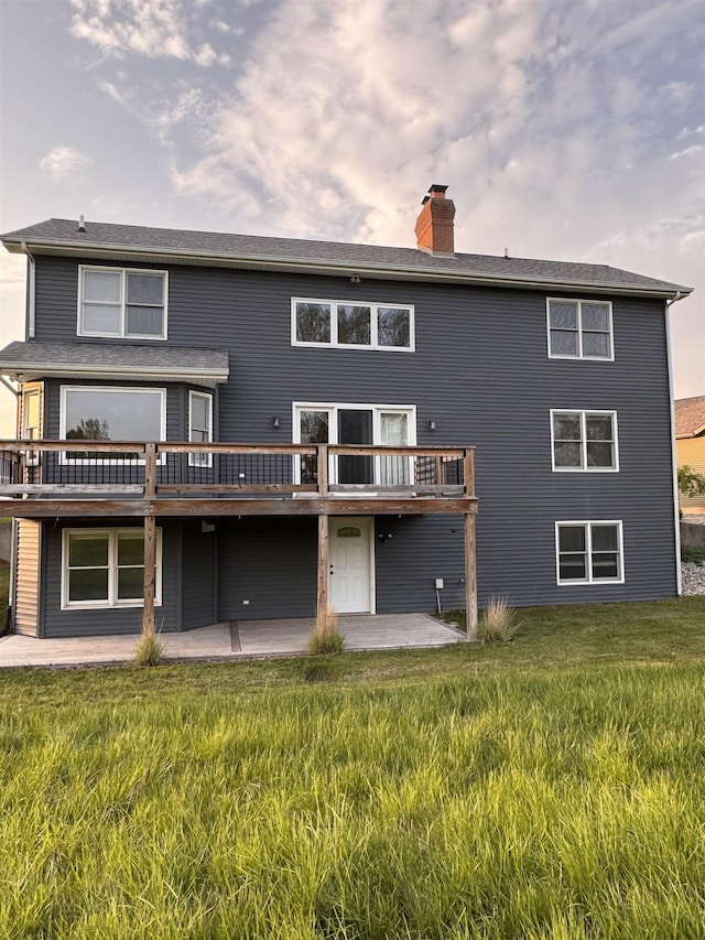 1953 S Troon Rd, Winona Lake, IN 46590 - back of property featuring a chimney, a patio, a wooden deck, and a yard