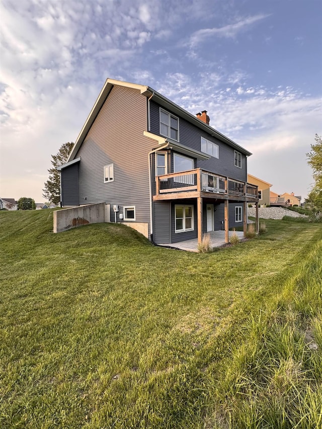 1953 S Troon Rd, Winona Lake, IN 46590 - back of property with a patio area, a deck, a lawn, and a chimney
