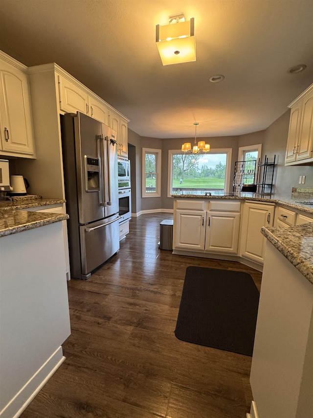 1953 S Troon Rd, Winona Lake, IN 46590 - kitchen with appliances with stainless steel finishes, a chandelier, dark wood-style floors, and healthy amount of natural light