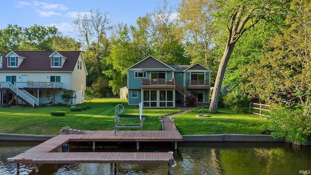 back of property with stairway, a deck with water view, and a sunroom