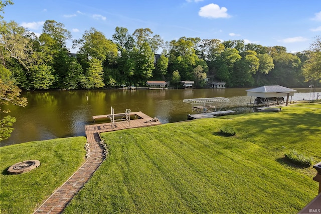 dock with a yard, a water view, and a fire pit