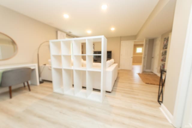 hallway featuring light wood-style floors and recessed lighting