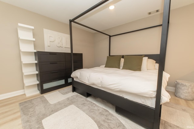 bedroom featuring wood finished floors and baseboards