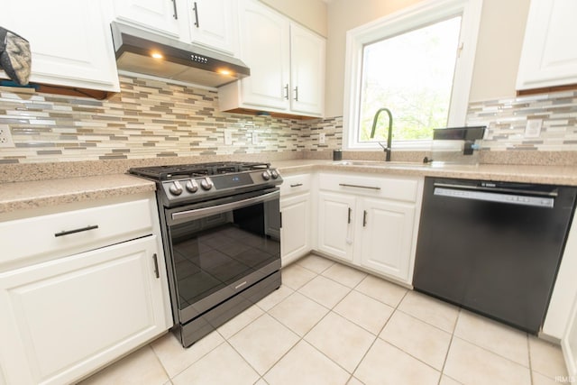 kitchen with dishwasher, stainless steel gas stove, under cabinet range hood, a sink, and white cabinetry