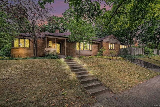 1402 E Colfax Ave, South Bend, IN 46617 - view of front of home with brick siding, a chimney, a porch, and stairs