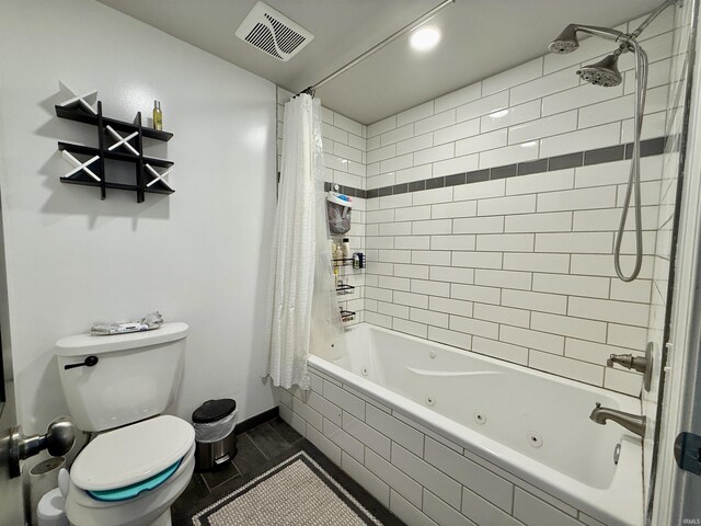 11475 Tedrow Ln, Shoals, IN 47581 - bathroom featuring toilet, a combined bath / shower with jetted tub, and baseboards