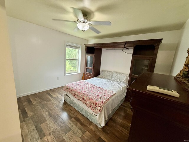 11475 Tedrow Ln, Shoals, IN 47581 - bedroom featuring dark wood-type flooring, a ceiling fan, and baseboards