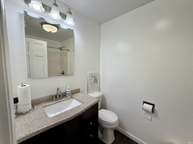11475 Tedrow Ln, Shoals, IN 47581 - bathroom with toilet, vanity, a shower, and baseboards
