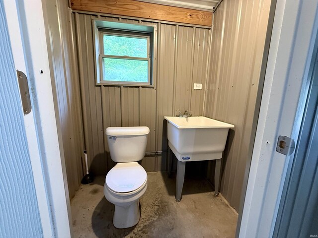 11475 Tedrow Ln, Shoals, IN 47581 - bathroom featuring toilet, unfinished concrete floors, and wood walls