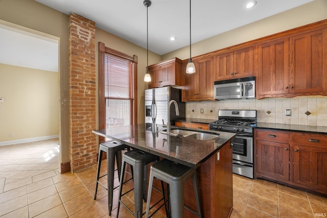 511 N 7th St, Lafayette, IN 47901 - kitchen featuring appliances with stainless steel finishes, a sink, backsplash, a breakfast bar area, and a center island with sink