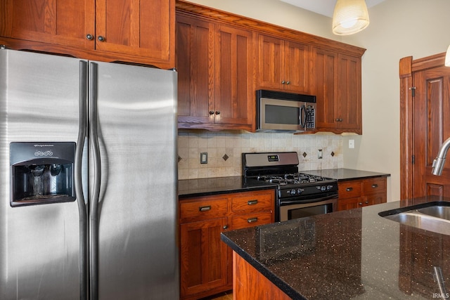 511 N 7th St, Lafayette, IN 47901 - kitchen featuring stainless steel appliances, a sink, decorative backsplash, dark stone countertops, and brown cabinetry